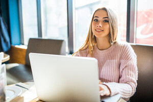 pretty-blonde-girl-fashion-white-sweater-working-her-laptop-computer-cafe-daily-time.jpg