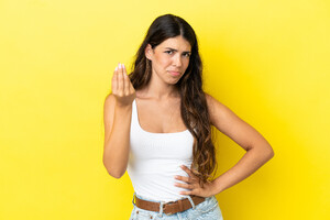 young-caucasian-woman-isolated-yellow-background-making-italian-gesture.jpg